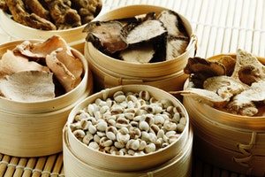 Dried mushrooms and other vegetable in baskets